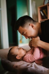 man looking down at baby