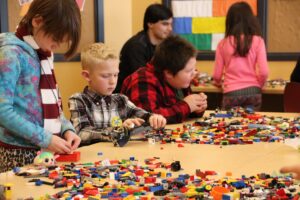 kids at table playing with Legos